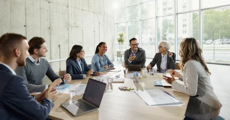 A cross-functional team gathered around a meeting table discussing an incident scenario